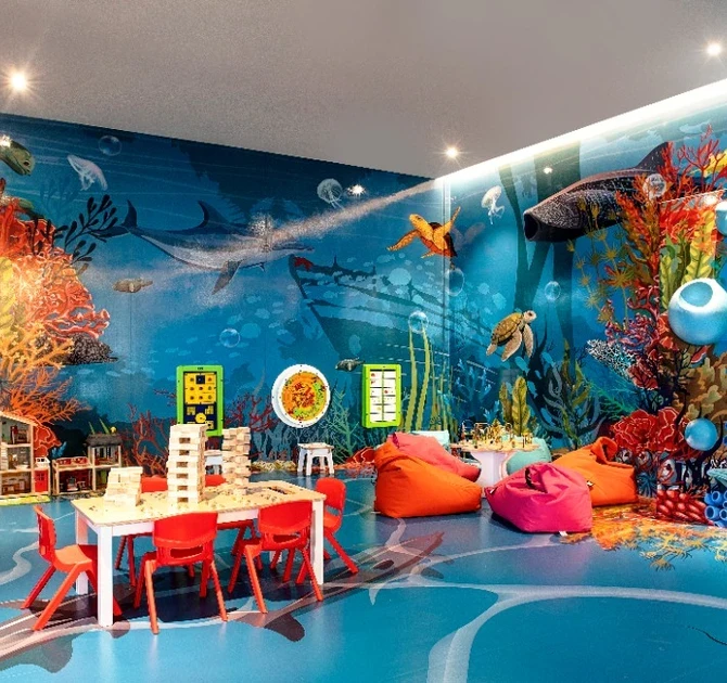 Sea-themed play zone with murals across the walls