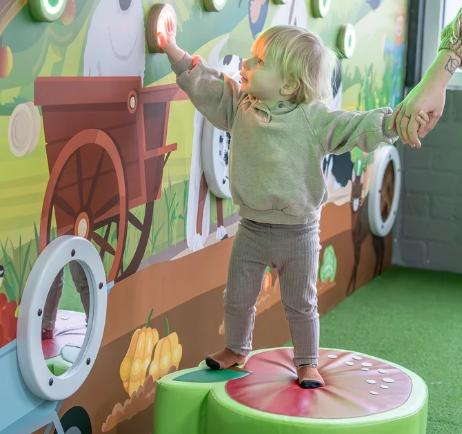 Child pressing the buttons on an IKC Experience Wall