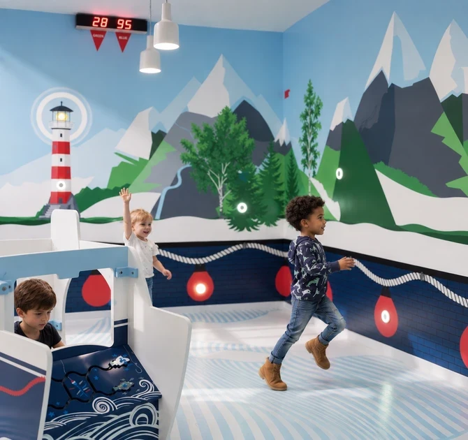 Two children playing on an IKC Activity Wall